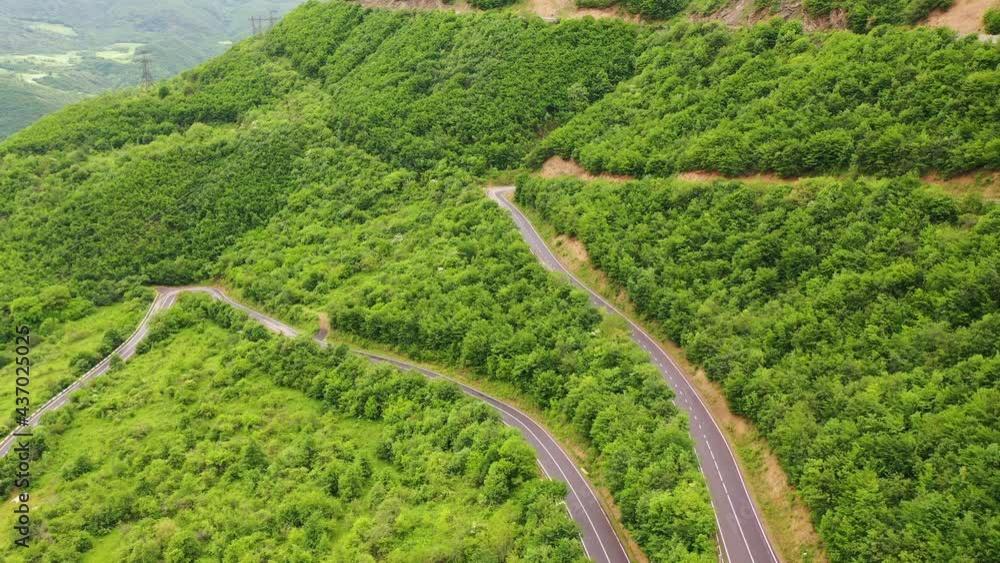Aerial view sharp turns in green mountains. Tatev's curves in Armenia. Aerial footage of winding mountain road. Aerial view sharp turns in green mountains. Tatev's curves in Armenia. Aerial footage of winding mountain road.