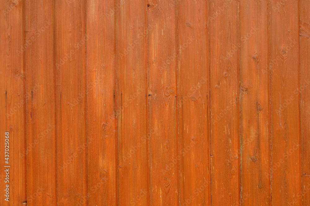 Naklejka premium The surface is made of wooden boards with knots, painted in orange with a highlighted texture.