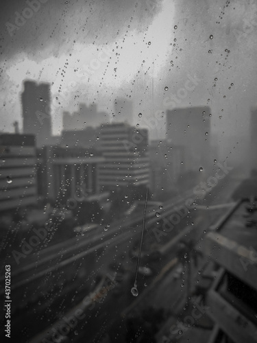 rain drop on office window with building background