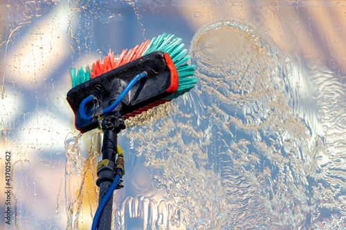 Obraz na plátně Close up telescopic window wiper tool, Telescopic handle with spiral and brush, Equipment for cleaning the window wiper, Outside budding glass washing with water and brush