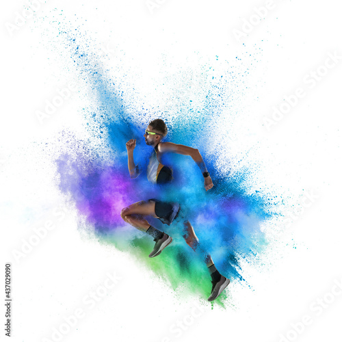 Young sportsman, male athlete running in explosion of colored powder explosion isolated on white background