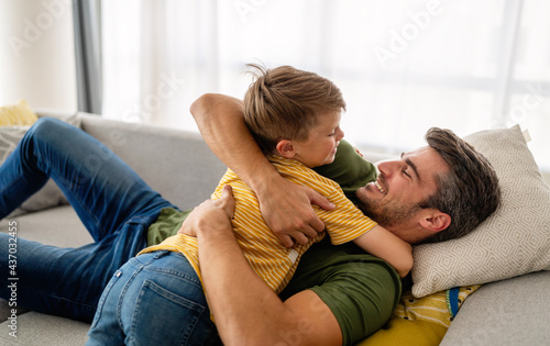 Happy family concept. Father playing with son at home.