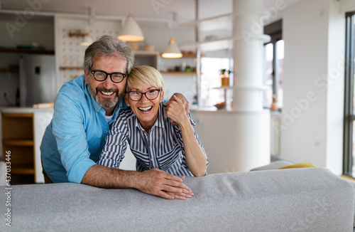 Fotografie Happy senior couple in love hugging and bonding with true emotions at home