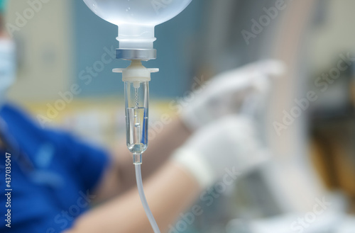Set vitamin iv fluid intravenous drop saline drip hospital room Medical Concept treatment emergency and injection drug infusion care chemotherapy concept.blue light background selective focus photo