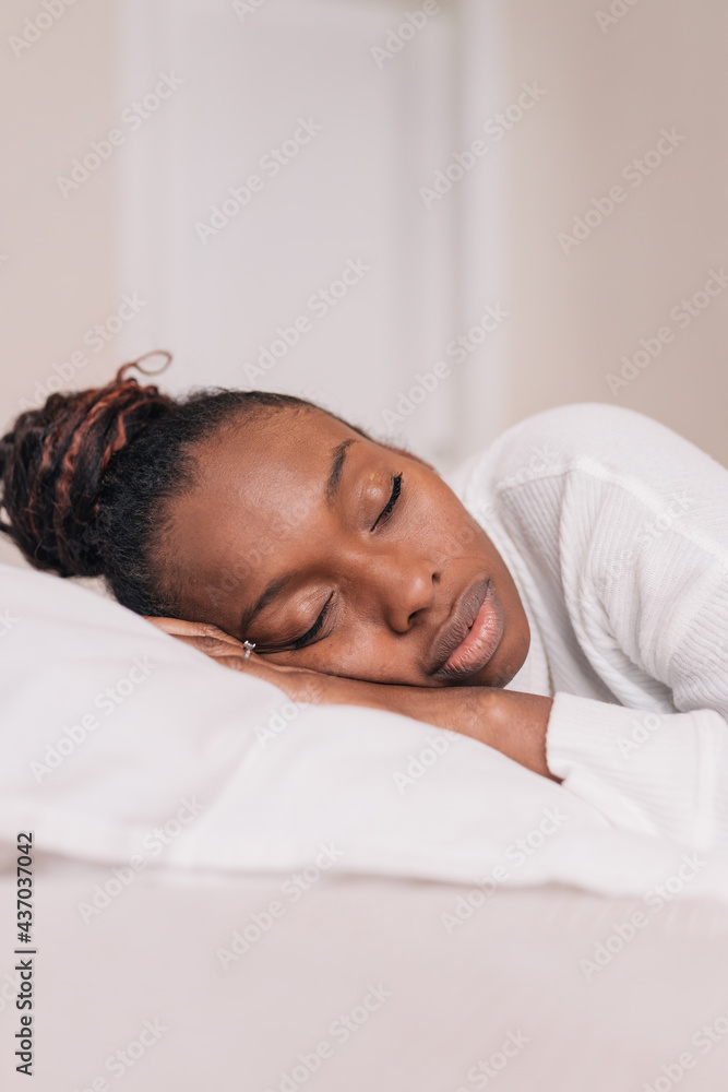 Young black woman sleeping on comfy bed at home Young black woman sleeping on comfy bed at home