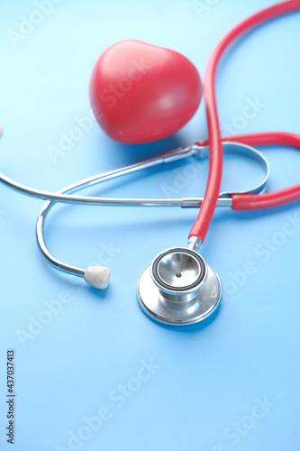 heart shape symbol and stethoscope on blue background 