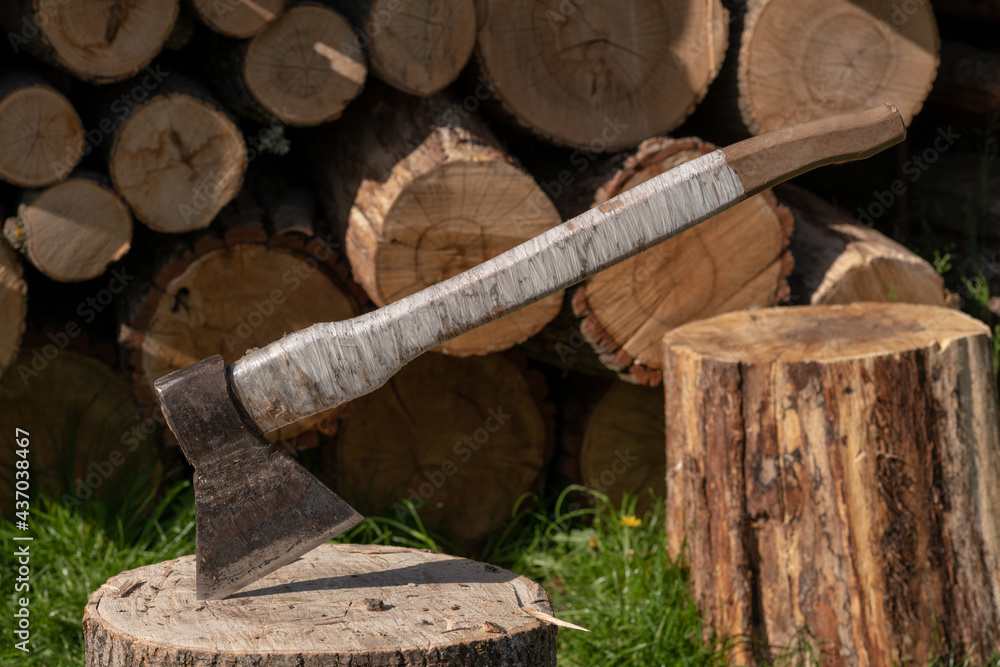 Photography on theme big steel axe with wooden handle Photography on theme big steel axe with wooden handle