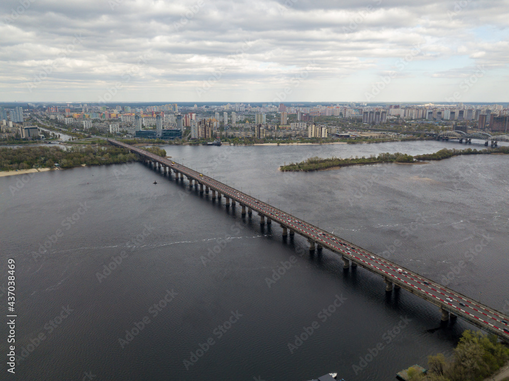 Automobile bridge across the Dnieper river in Kiev. Aerial drone view.