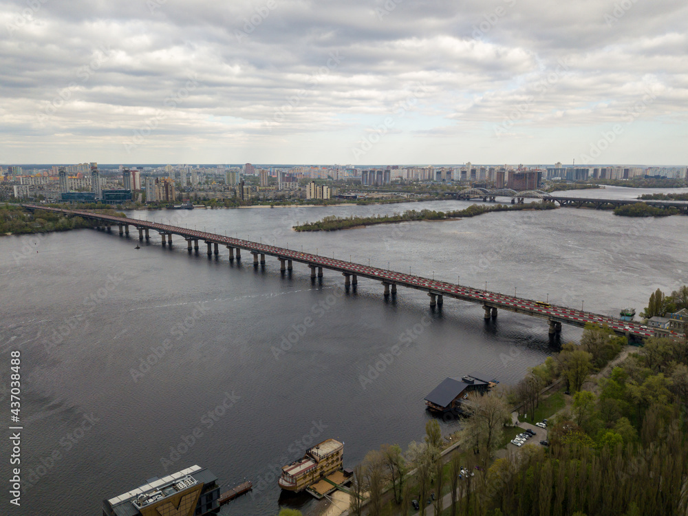 Automobile bridge across the Dnieper river in Kiev. Aerial drone view.