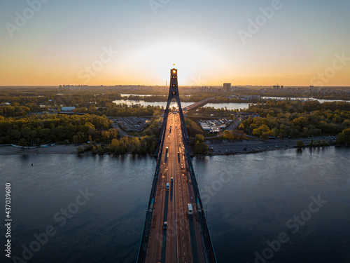 North bridge in Kiev. Rising sun rays along the bridge. Sunrise through the pylon. Aerial drone view.