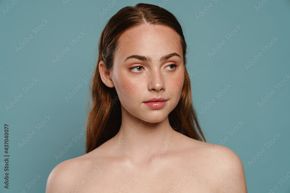 Half-naked ginger woman posing and looking aside Half-naked ginger woman posing and looking aside