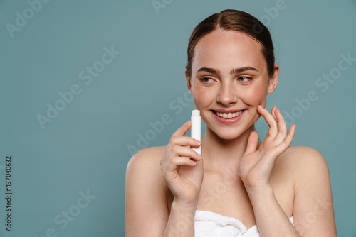 Young brown haired woman showing lip balm photo