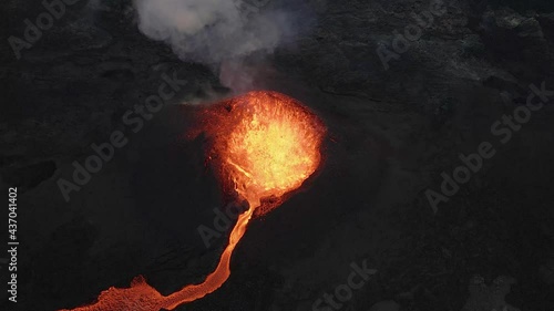 Crazy aerial top-down over fountain of magma erupting from volcano crater, Iceland photo