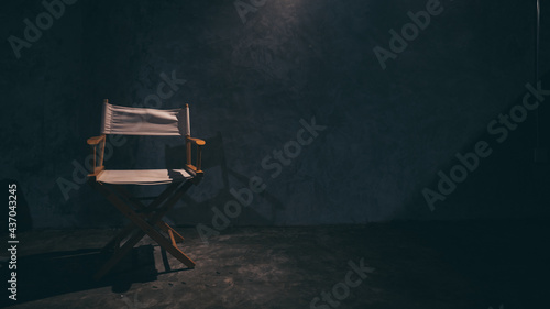 single wood director chair, furniture seat setting in cinema studio, industry film entertainment stage, white and black tone in vintage filter style, art folding object for filmmaker and actor photo