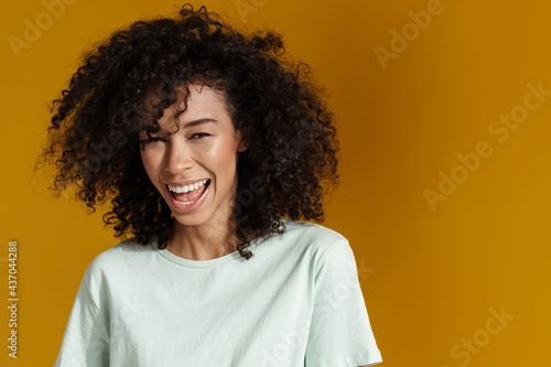 Young african woman laughing and looking at camera