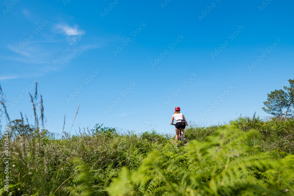 pretty young athletic woman mountain biking in nature pretty young athletic woman mountain biking in nature
