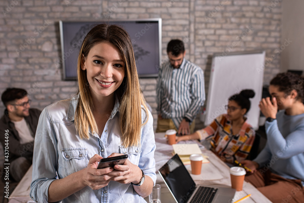 Portrait of young female leader standing in office looking at camera. Portrait of young female leader standing in office looking at camera.