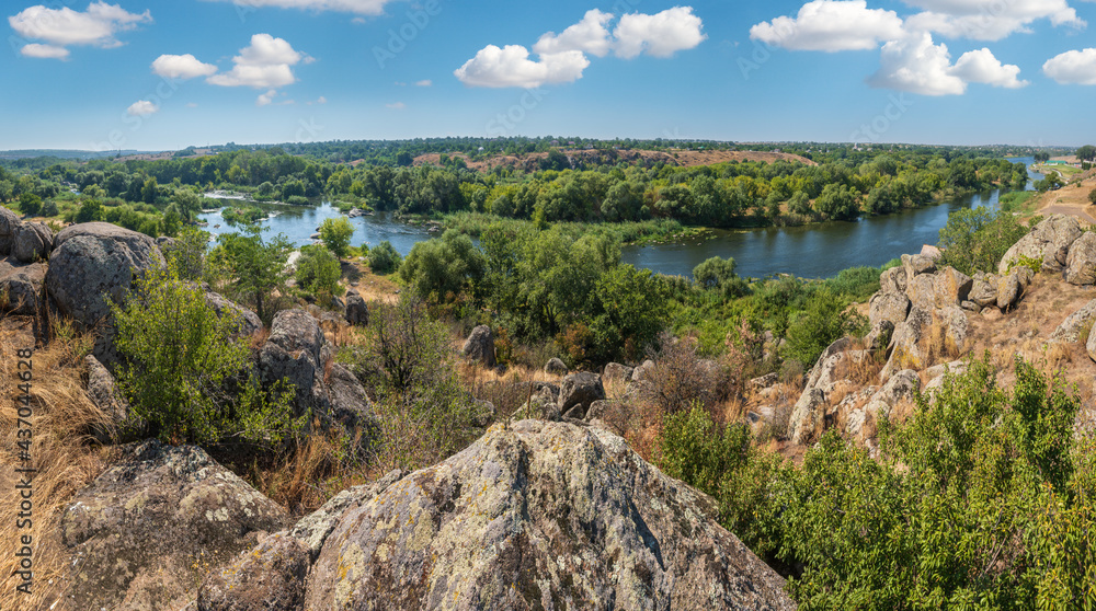 Summer Pivdennyi Buh (Southern Bug) river in Myhiya, Mykolayiv Region, Ukraine. Landscape of the river with rocky coast.