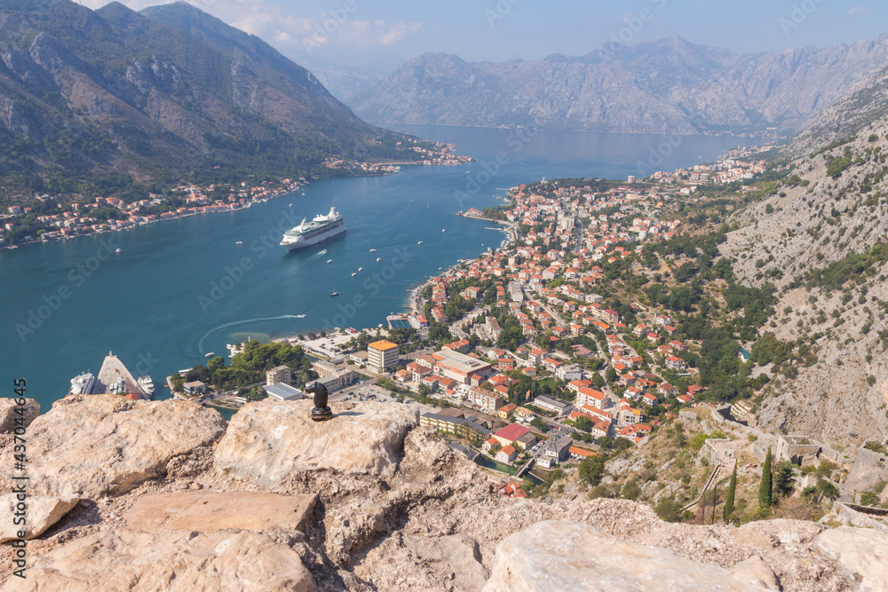 A black knight  stands on a stone fence above the town of Kotor. Montenegro 