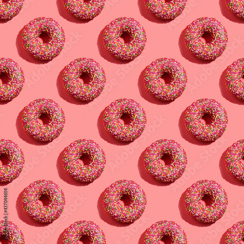 Donuts seamless pattern in pink glaze on pink background