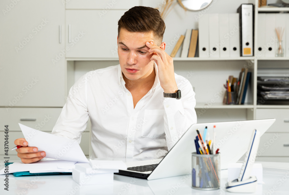 european guy in white shirt puzzled by problems in office european guy in white shirt puzzled by problems in office