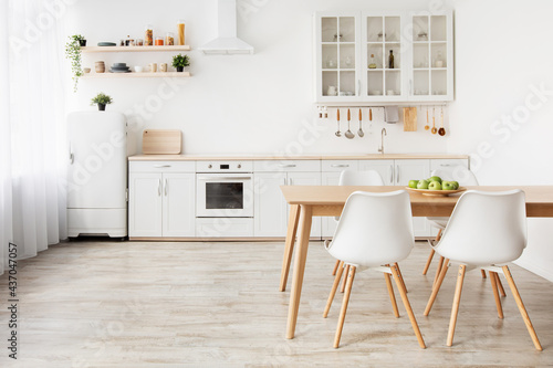 Home nordic interior. Idea of light scandinavian kitchen interior with white and wooden dining furniture  empty space