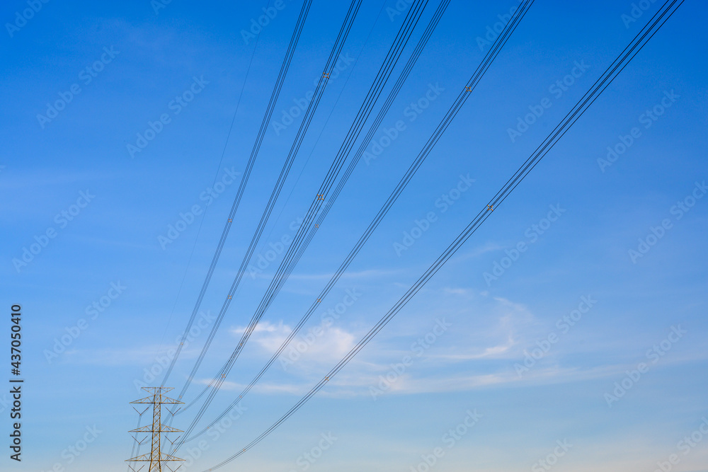 Electric poles and lines at dusk or high voltage towers at beautiful sky