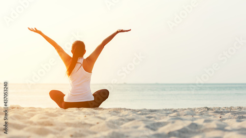 Lifestyle woman worm up raise arm before pose for healthy life. Young people sitting yoga exercise and pose balance body vital zen and meditation workout and fitness sport outdoor sunset photo