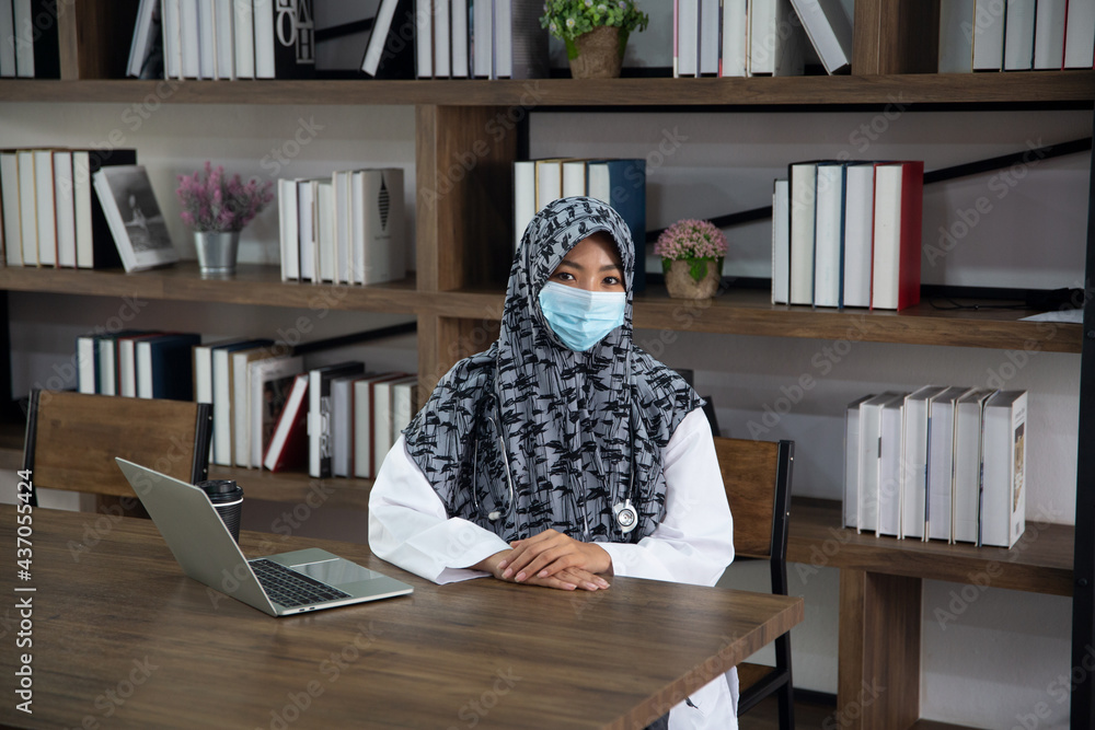 Young saudi business woman working in at home, pointing on laptop, copy space. Muslim female working with computer in the room , writing paper. Young muslim woman using laptop Young saudi business woman working in at home, pointing on laptop, copy space. Muslim female working with computer in the room , writing paper. Young muslim woman using laptop