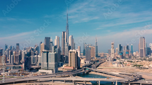 Fototapeta Naklejka Na Ścianę i Meble -  AERIAL. Drone video of Dubai city at day time. Modern city concept vith transport and river.