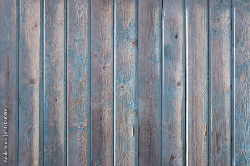 old board background with shabby blue paint. close-up.