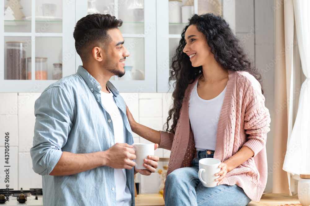 Fototapeta premium Loving Middle Eastern Couple Bonding While Drinking Coffee In Kitchen