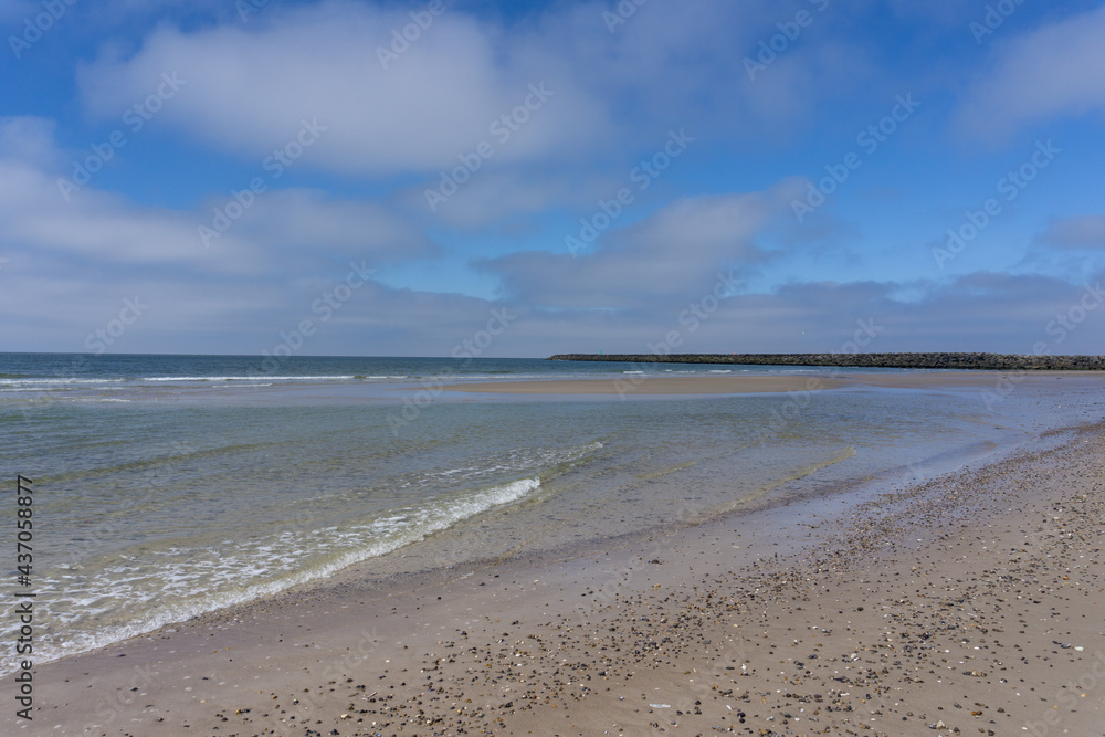 beautiful clear water and sandy beach under a blue sky on the western coast of Denmark