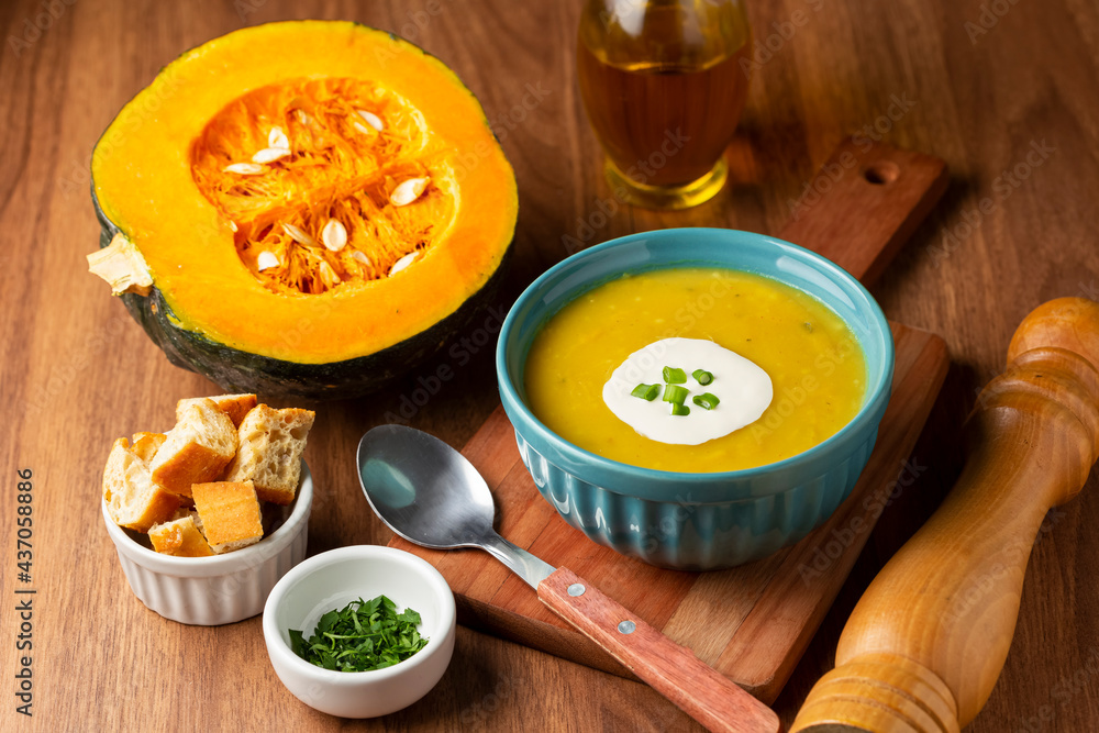 Bowl with pumpkin soup on the table. Bowl with pumpkin soup on the table.