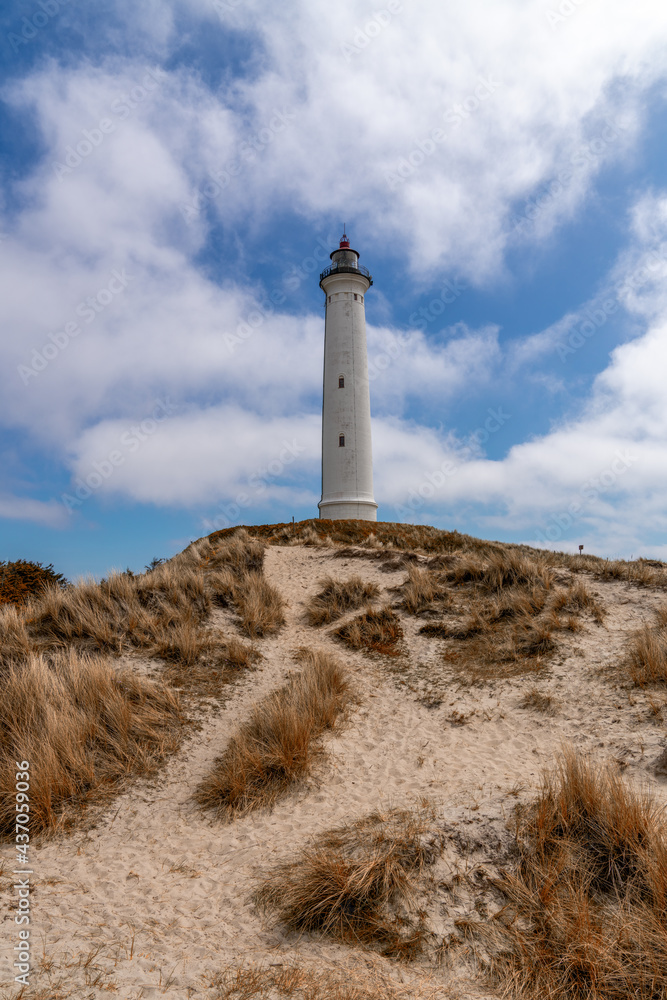 view of sand dunes on the Jutland coast of Denmark with the Lyngvid Fyr lighthouse