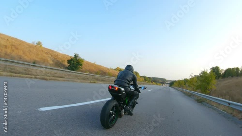 Wallpaper Mural Follow to motorcyclist riding on modern sport motorbike at highway. Biker racing his motorcycle on country road. Guy driving bike during trip. Concept of freedom and adventure at journey. Aerial shot Torontodigital.ca