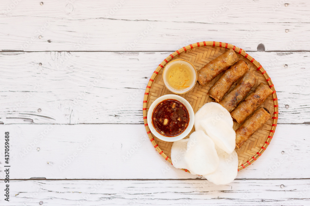 Traditional Vietnamese juicy and crispy rolls on a wooden board