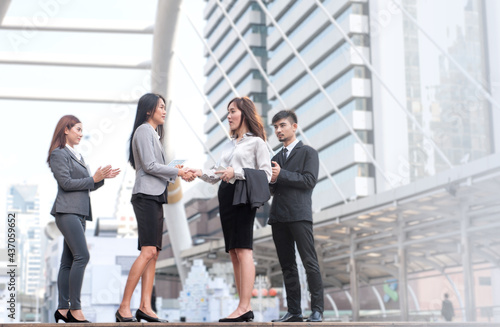 Businessmen shake hands after successful negotiations.