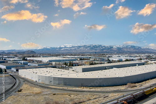 Aerial view of the Sparks and Reno industrial area facing southwest towards the snowcapped mountains of MT. Rose and Slide mountain in late springtime.