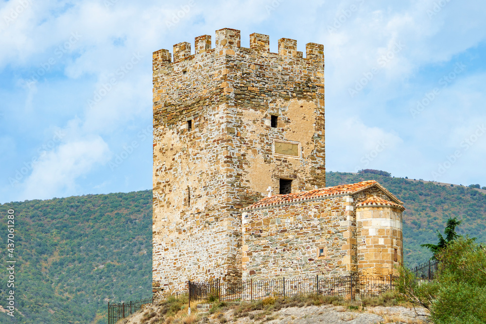 Ancient port tower of Genoese fortress and Church of 12 Apostles in Sudak, Crimea. Both buildings were built in XIV century.