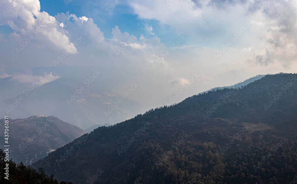 Obraz premium mountain layers with cloudy sky at morning from flat angle