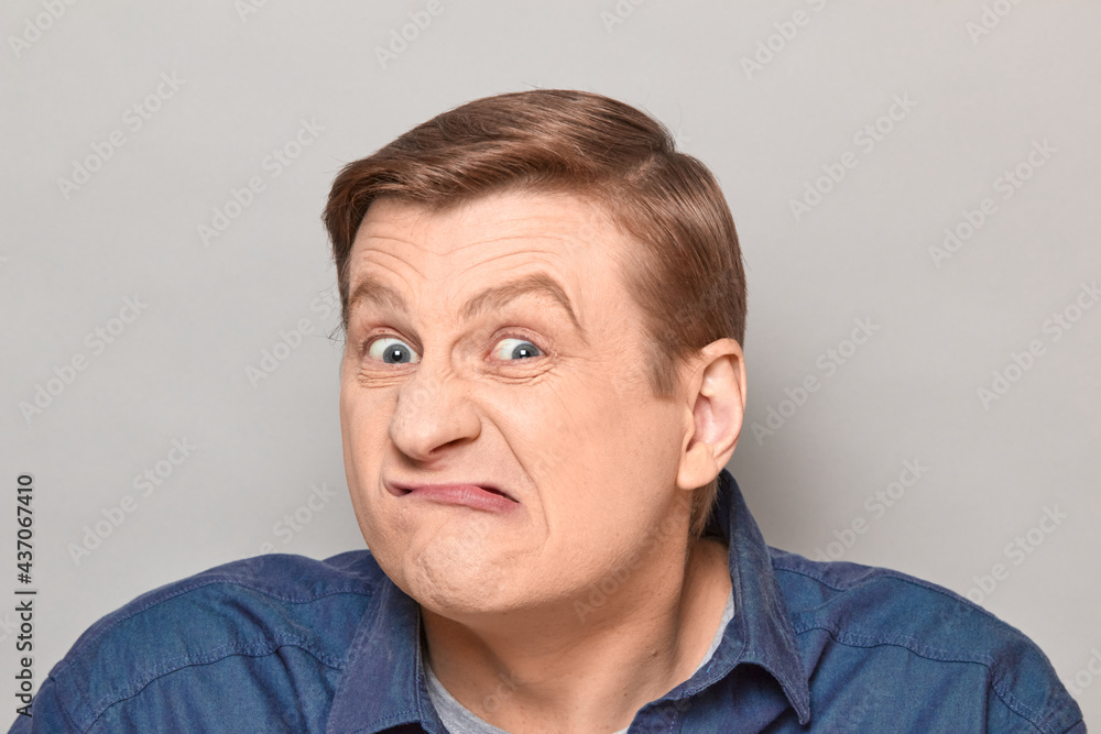 Portrait of funny man grimacing and making goofy crazy face Portrait of funny man grimacing and making goofy crazy face