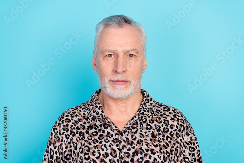 Photo of strict grey aged man wear leopard shirt isolated on bright blue color background