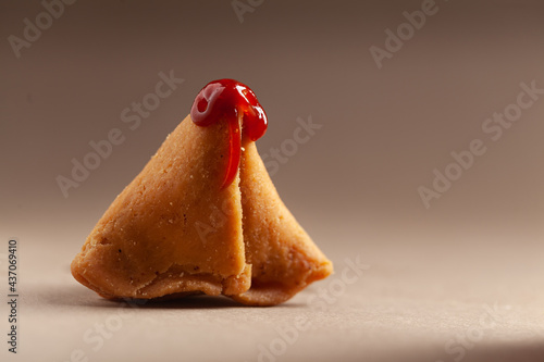 Принти на полотні Close-up of freshly baked spicy and sweet samosa filled with dry fruits spicy dry chutney traditionally authentic Rajisthani with tomato ketchup