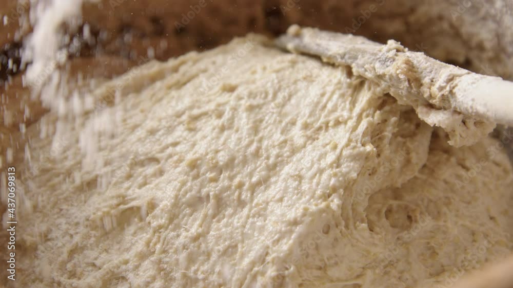 BAKING - Sprinkling a little flour during sourdough bread baking, slow motion BAKING - Sprinkling a little flour during sourdough bread baking, slow motion