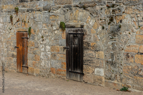 Old wooden doors in the stone wall