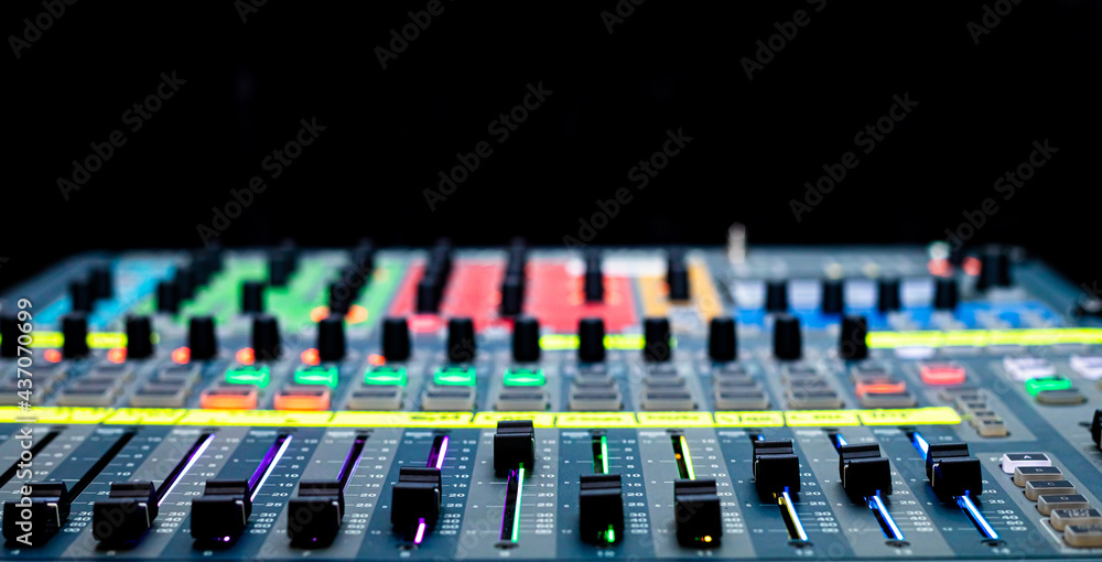 Sliders and buttons on Audio Mixing Desk at live event. Sliders and buttons on Audio Mixing Desk at live event.