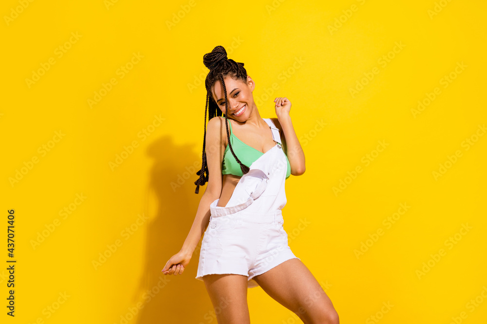 Photo of charming joyful dark skin young woman enjoy summer good mood isolated on yellow color background Photo of charming joyful dark skin young woman enjoy summer good mood isolated on yellow color background