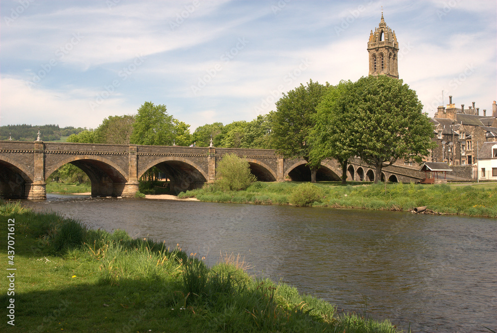 arched bridge over river Tweed and church tower at Peebles in summer