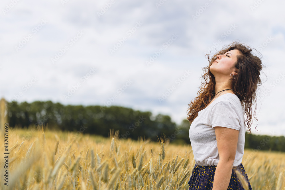 Young carefree woman in rustic dress Breathing Deep Fresh Air In A grassy Field. Space for text. walking in summer meadow. Atmospheric authentic moment. Rural slow life Young carefree woman in rustic dress Breathing Deep Fresh Air In A grassy Field. Space for text. walking in summer meadow. Atmospheric authentic moment. Rural slow life